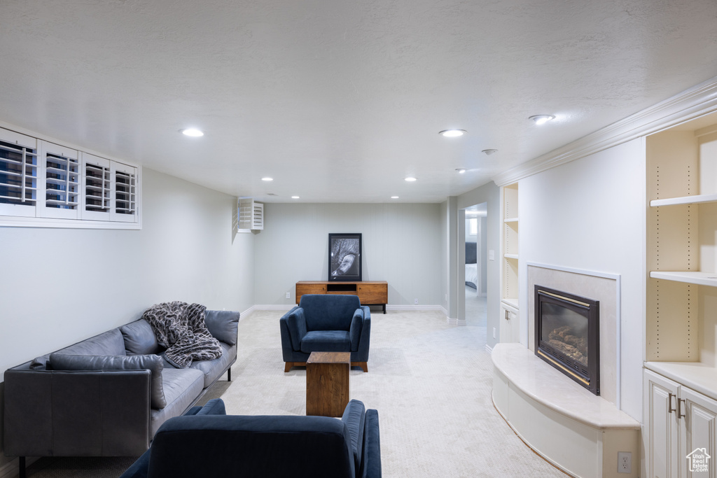 Living room featuring light colored carpet, recessed lighting, and a fireplace