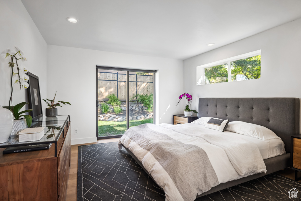Bedroom featuring multiple windows, dark wood finished floors, recessed lighting, access to exterior, and baseboards
