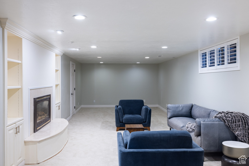 Living room with recessed lighting, a fireplace, light colored carpet, and baseboards