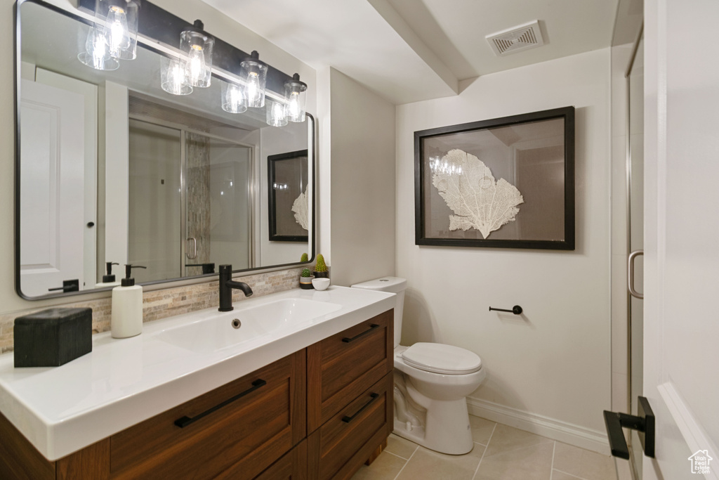 Full bathroom featuring a shower stall, vanity, and tile patterned floors