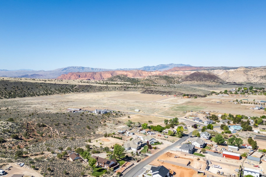 Aerial view of property and surrounding area with mountains, a desert landscape, and rural landscape