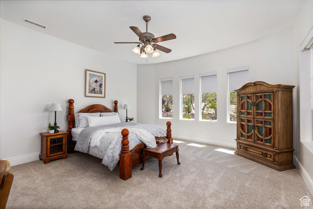 Carpeted bedroom featuring baseboards and ceiling fan