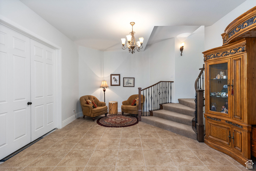 Sitting room featuring a chandelier and stairway