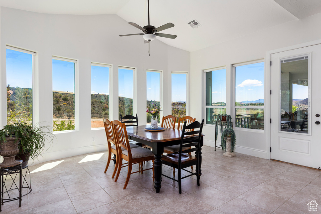 Sunroom / solarium featuring vaulted ceiling and tile patterned flooring