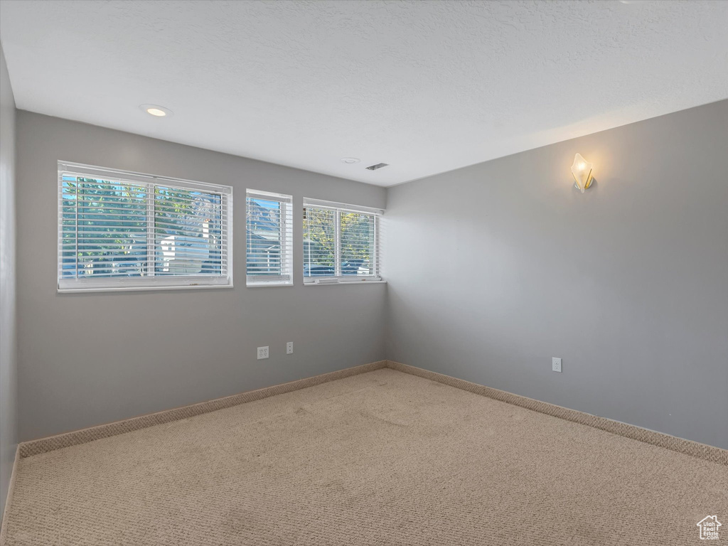 Unfurnished room with carpet, baseboards, and recessed lighting