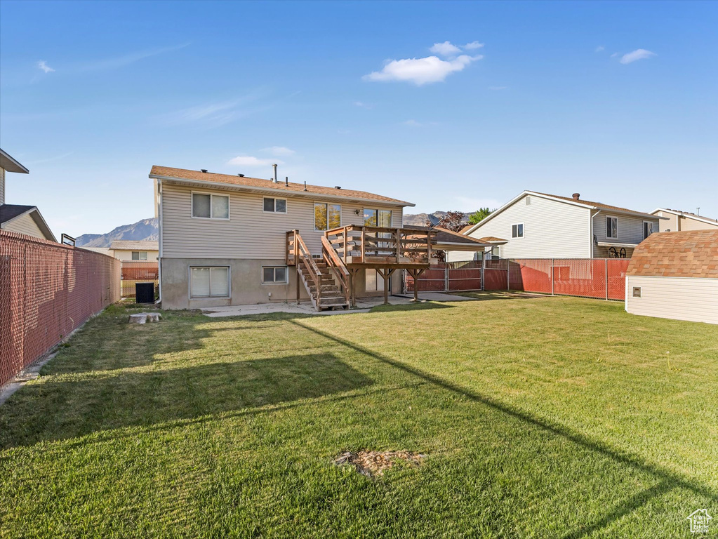 Rear view of property with stairs, a wooden deck, and cooling unit
