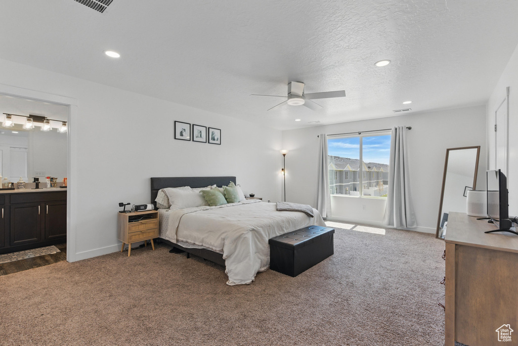 Bedroom featuring carpet floors, recessed lighting, ensuite bath, baseboards, and a textured ceiling