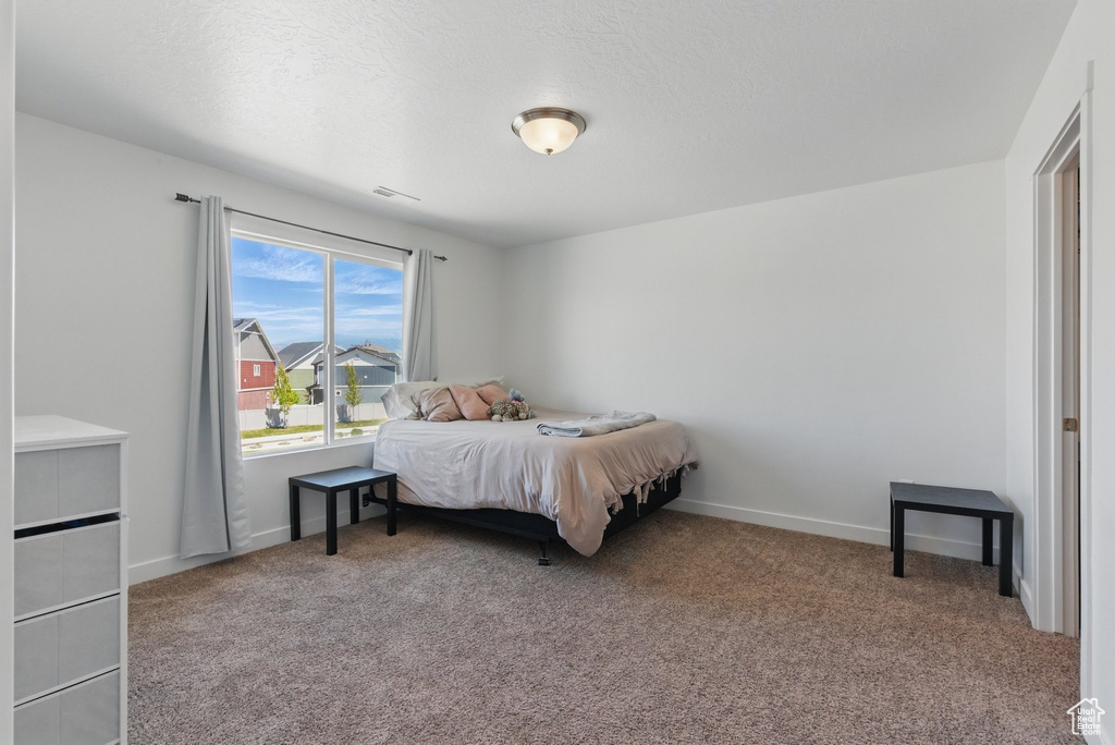 Carpeted bedroom featuring baseboards