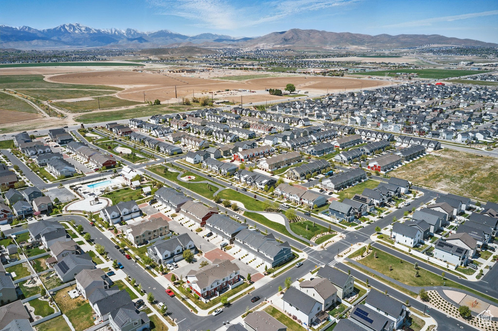 Aerial overview of property\'s location with nearby suburban area and a mountainous background