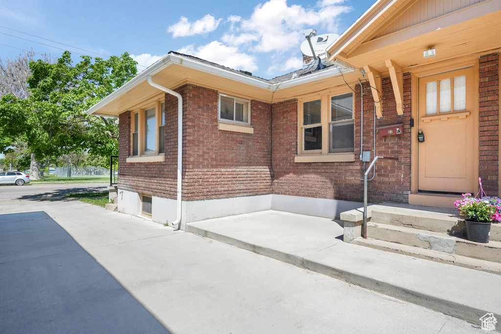 View of side of home featuring brick siding