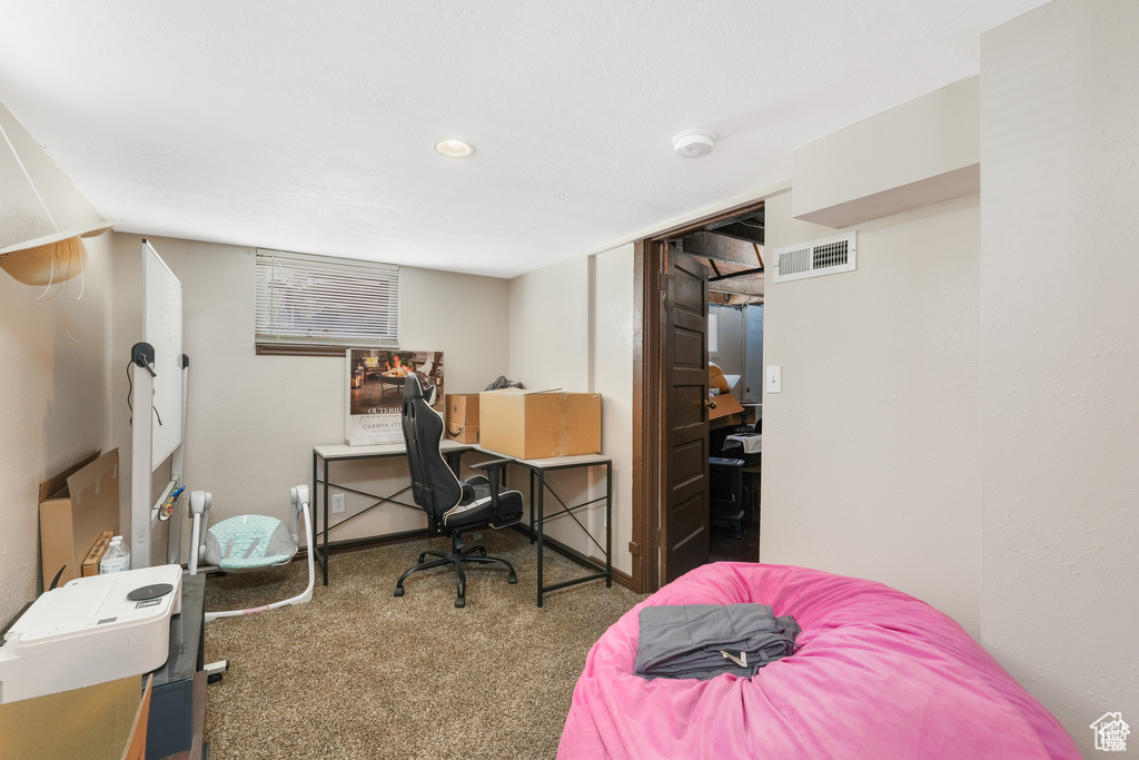 Home office featuring carpet floors and visible vents