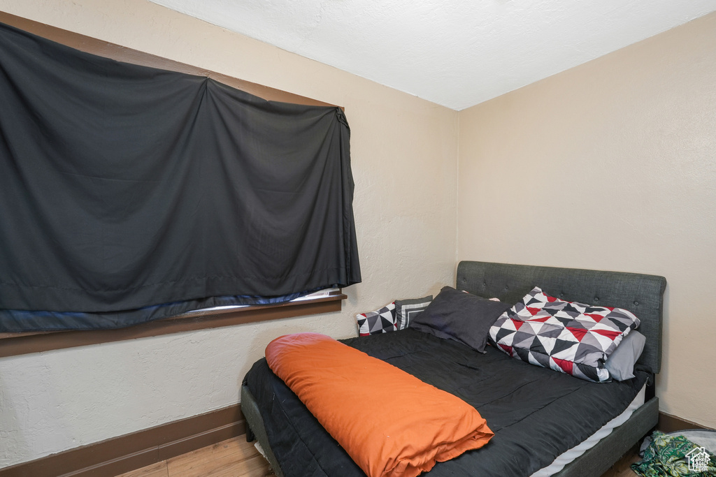 Bedroom with baseboards and wood finished floors