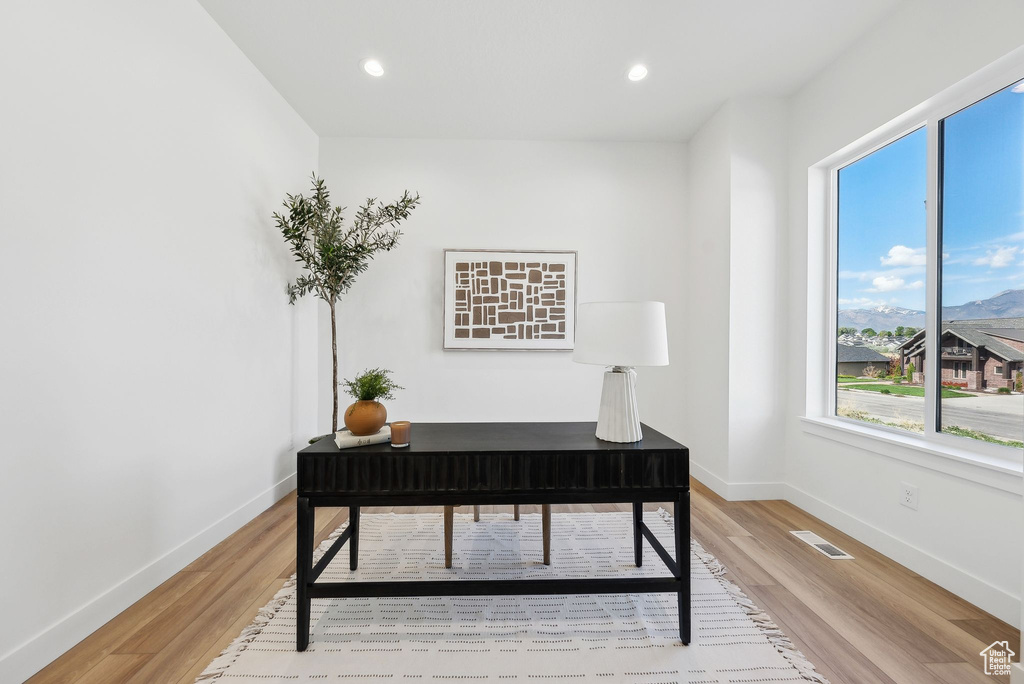 Home office with light wood-type flooring, baseboards, and recessed lighting