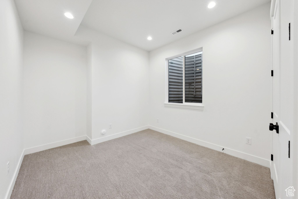 Carpeted spare room featuring recessed lighting and baseboards