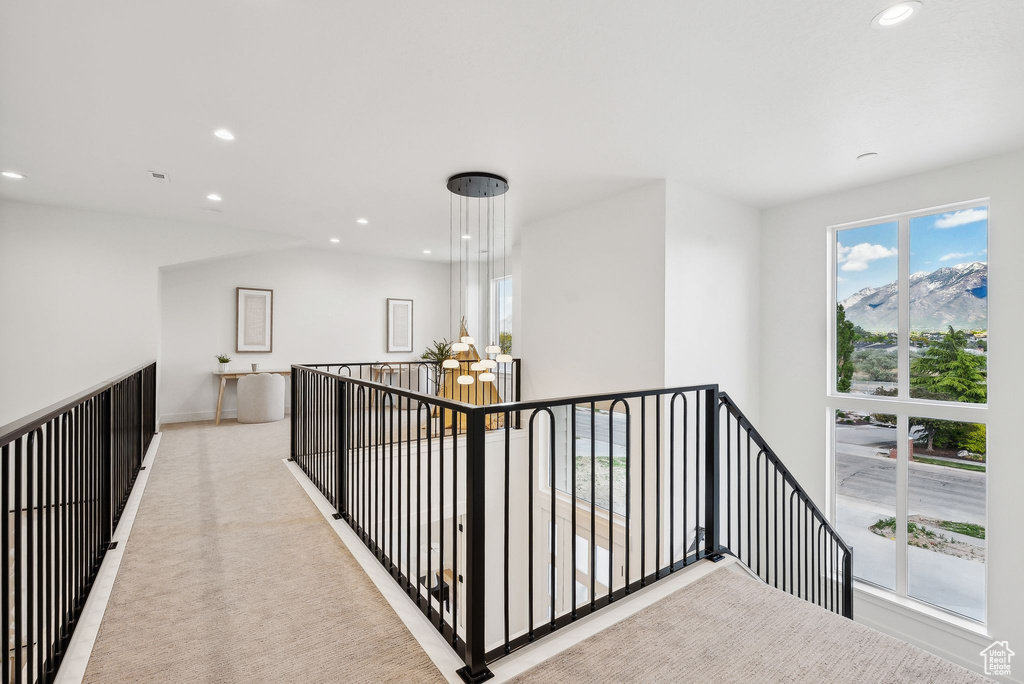 Corridor featuring recessed lighting, an upstairs landing, baseboards, and light carpet