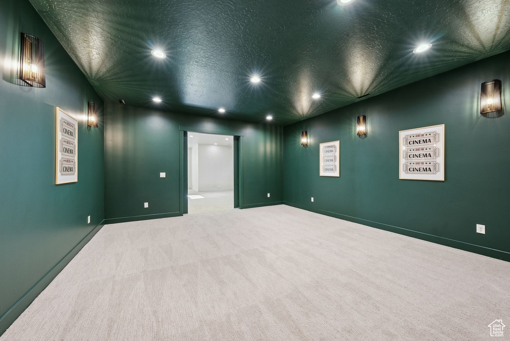 Spare room featuring recessed lighting, carpet, a textured ceiling, and baseboards