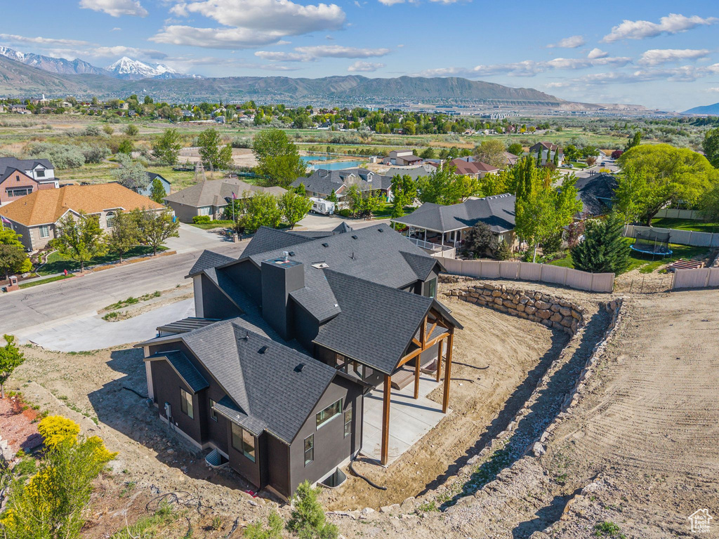 Aerial view of residential area featuring a mountainous background