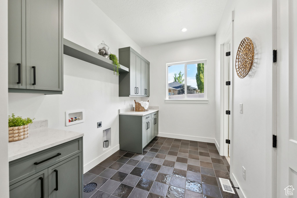 Laundry room featuring cabinet space, electric dryer hookup, baseboards, washer hookup, and recessed lighting