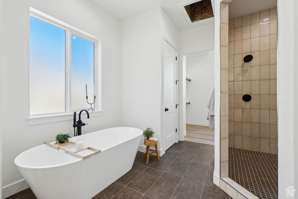 Bathroom featuring walk in shower and a freestanding bath