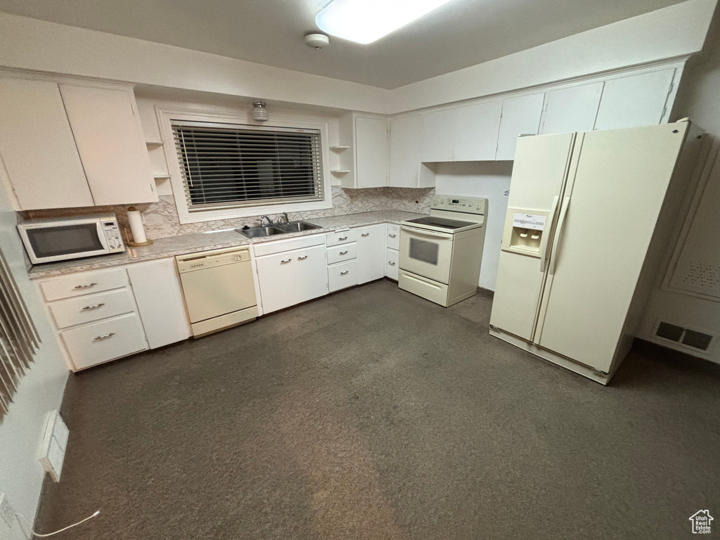 Kitchen featuring white appliances, open shelves, a sink, light countertops, and white cabinets