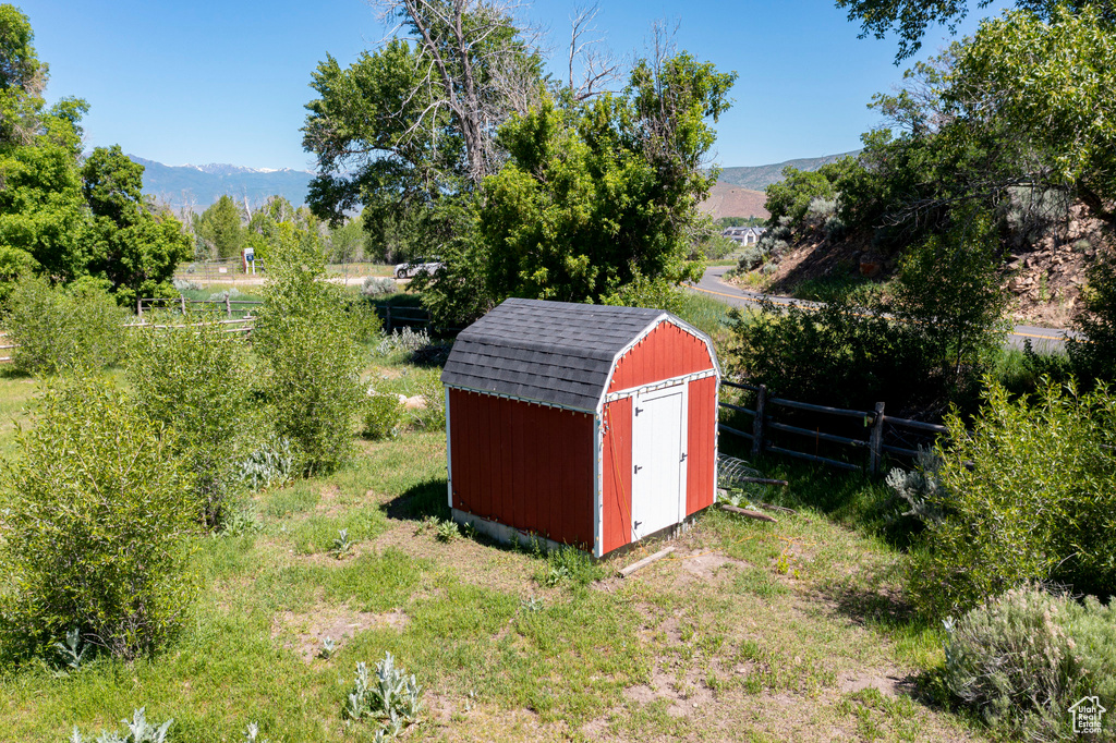 View of shed with fence and a mountain view