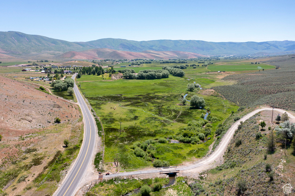 Aerial view of property and surrounding area with mountains and rural landscape