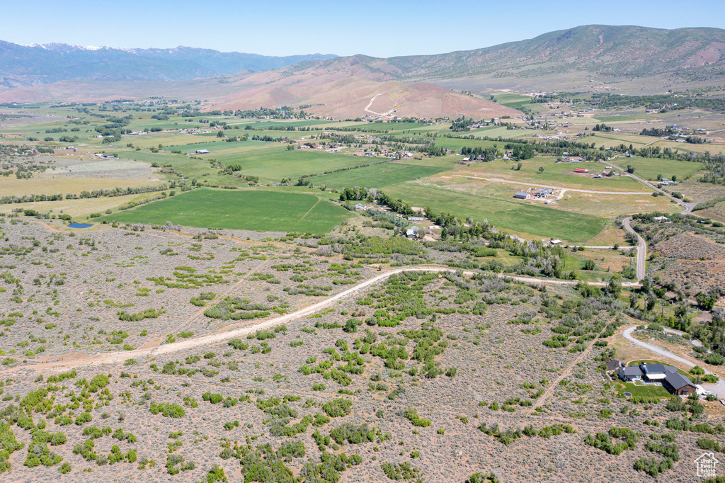 Aerial overview of property\'s location with rural landscape and a mountainous background