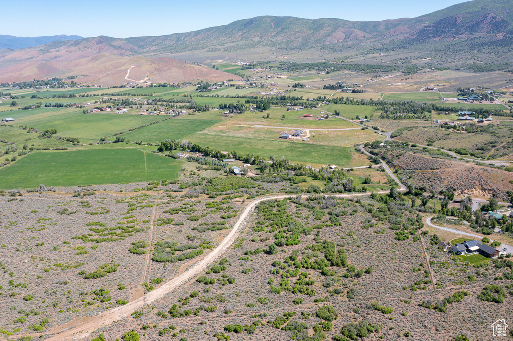 Aerial overview of property\'s location with rural landscape and a mountainous background