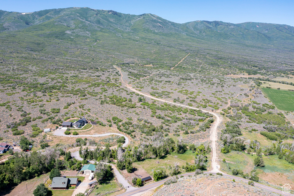 Aerial view of property\'s location featuring rural landscape and a mountain backdrop