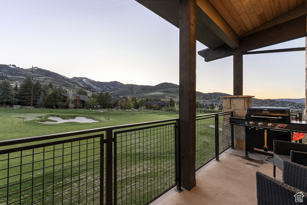 Balcony featuring a mountain view and a grill