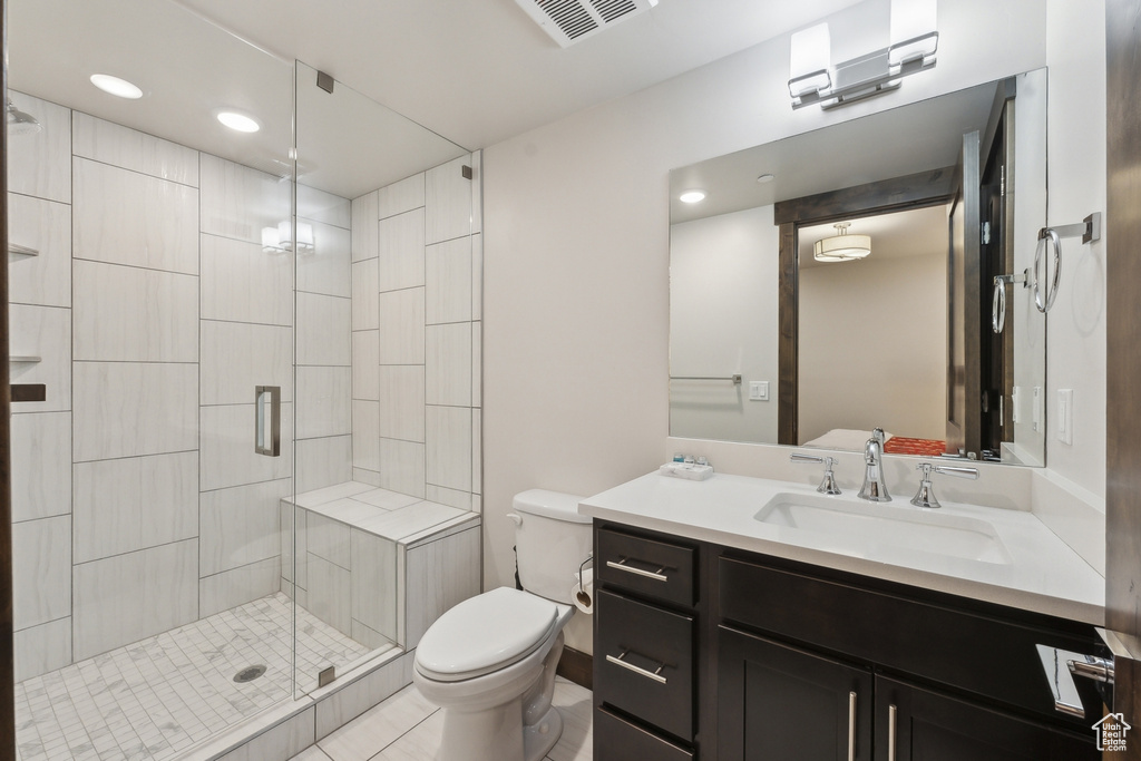 Full bath featuring a shower stall, toilet, vanity, recessed lighting, and tile patterned floors