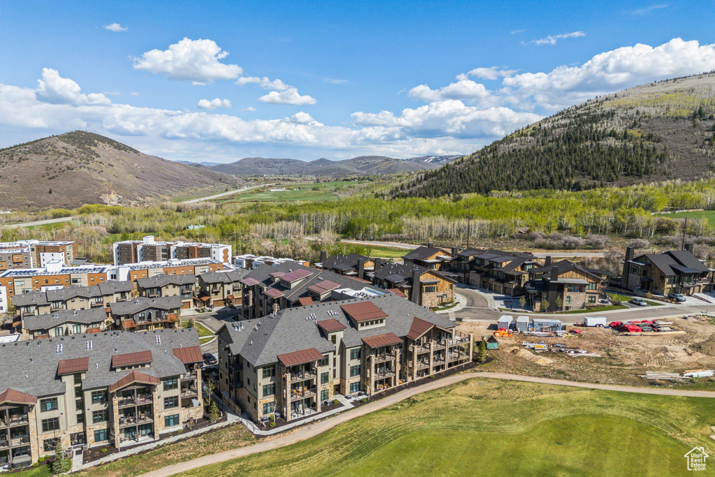 Aerial perspective of suburban area with a mountain backdrop and a local golf course