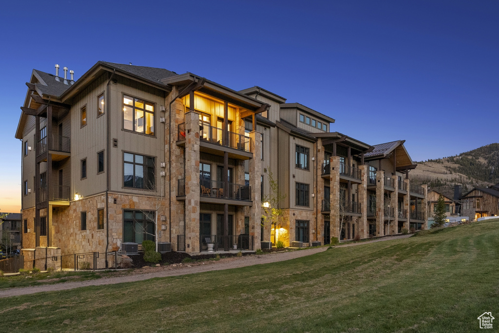 View of property at dusk