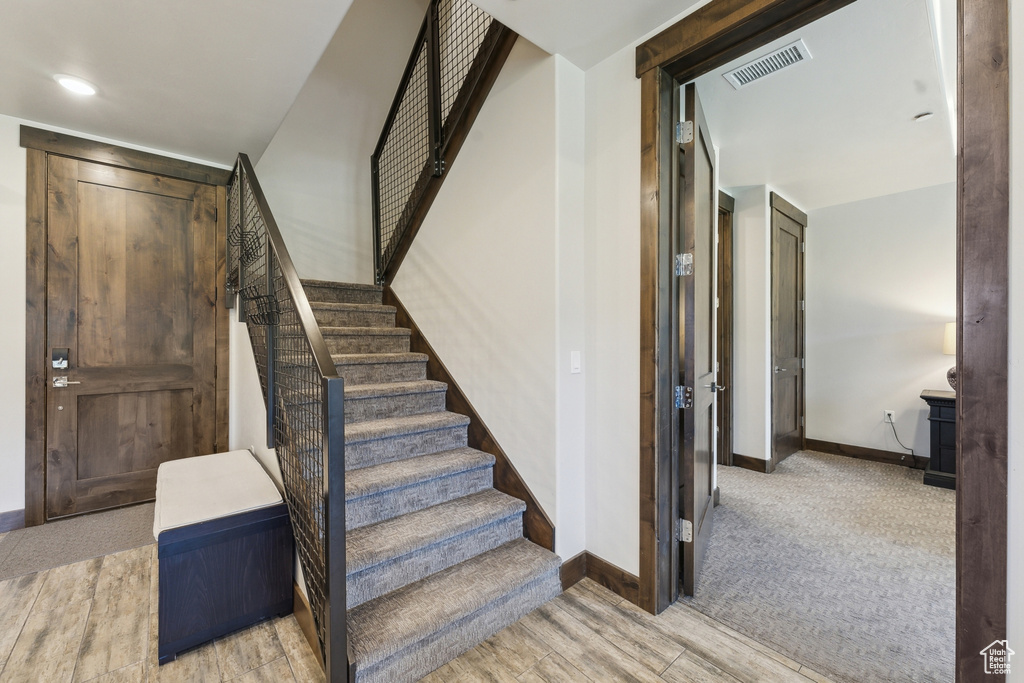Stairway with baseboards and wood finished floors