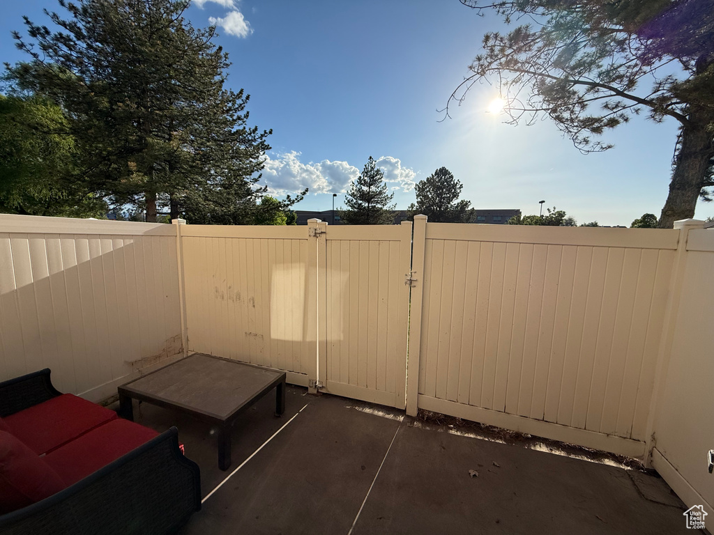 View of patio featuring fence