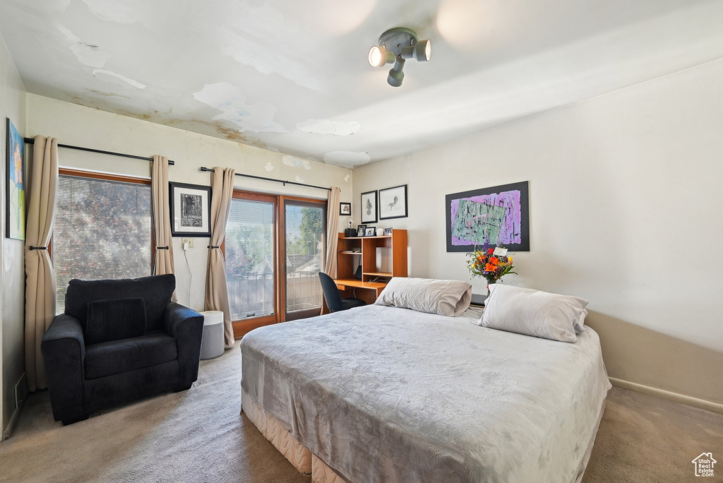 Bedroom with carpet flooring and access to exterior