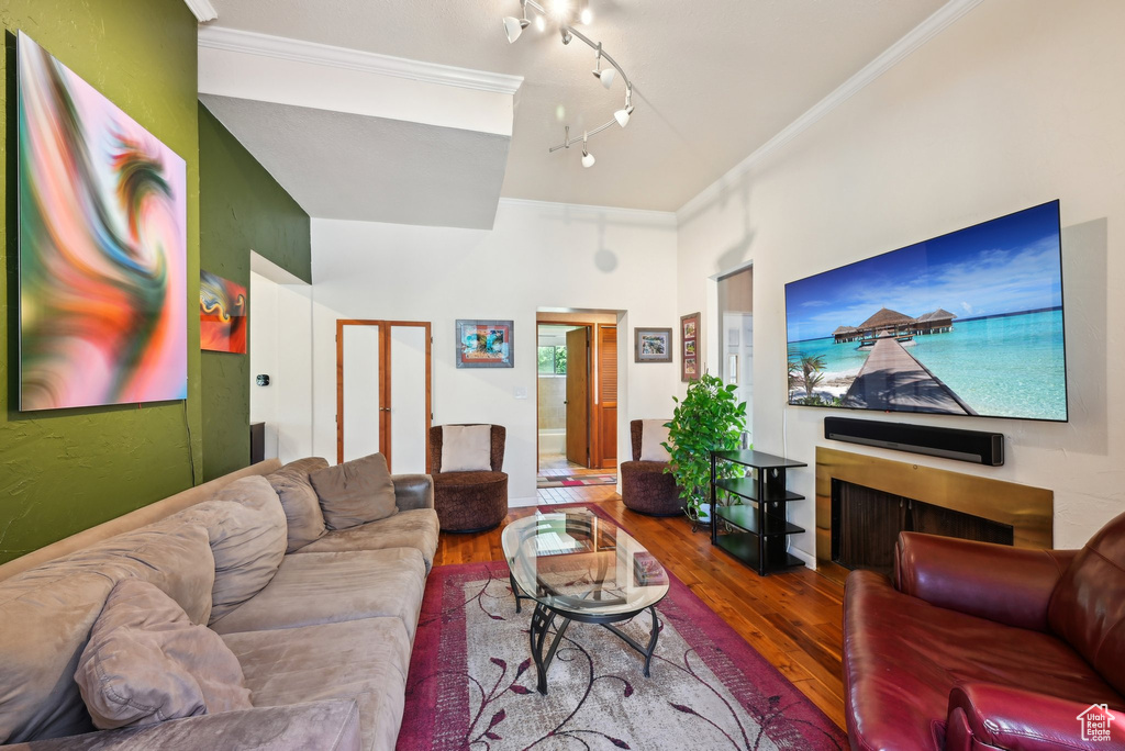 Living room with hardwood / wood-style floors and ornamental molding