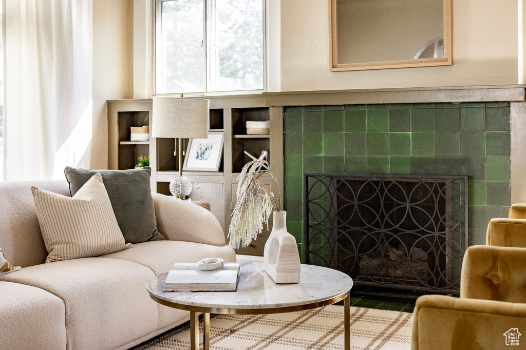 Living area featuring a tile fireplace