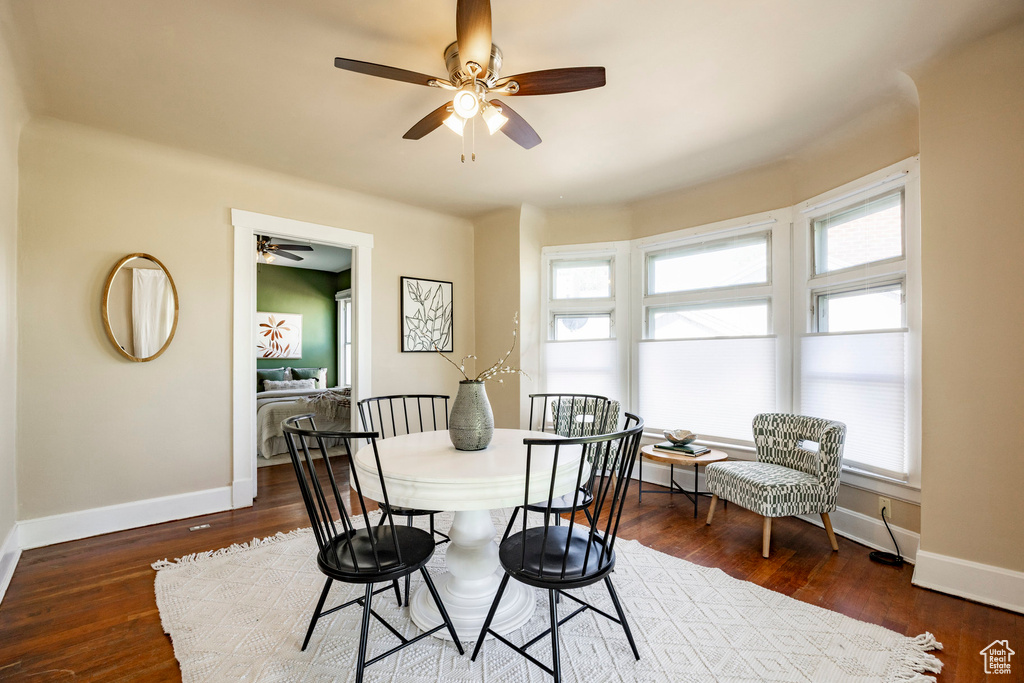 Dining room with ceiling fan, baseboards, and wood finished floors