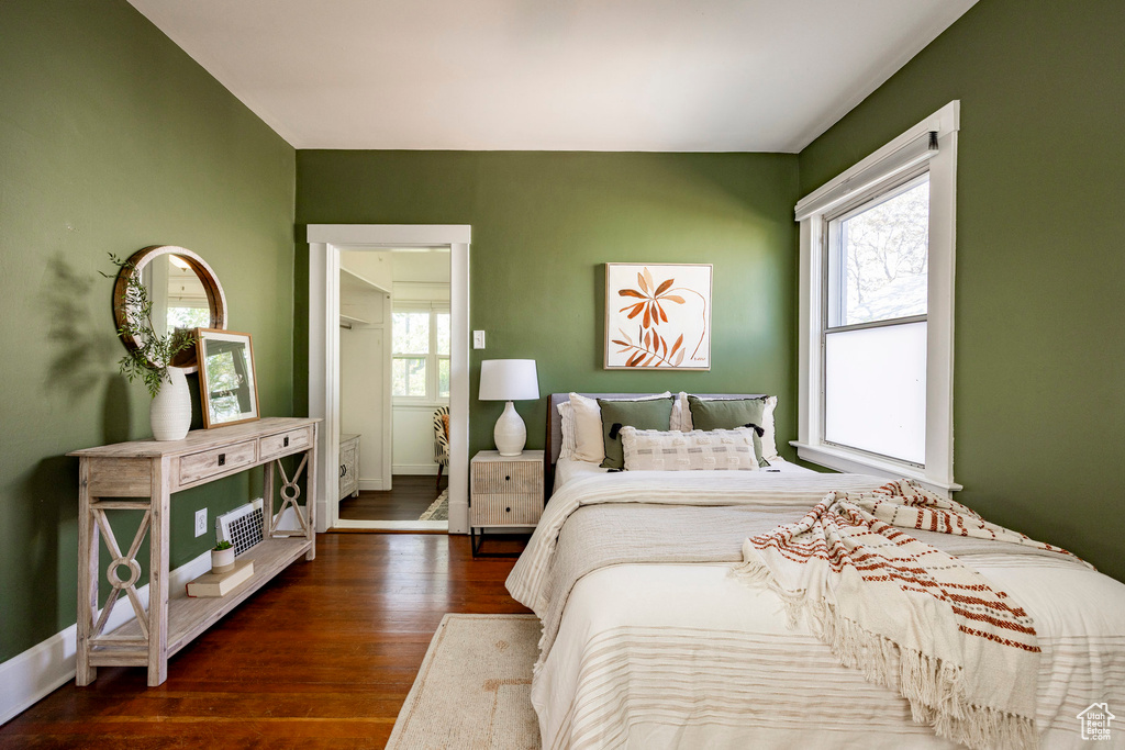 Bedroom with wood finished floors and baseboards