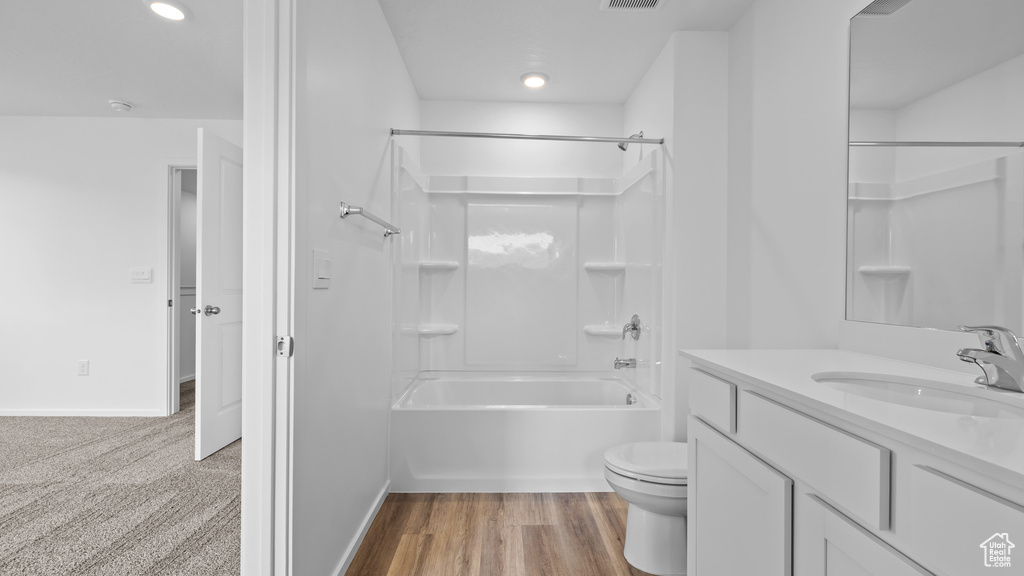 Full bathroom featuring toilet, vanity, shower / bath combination, baseboards, and recessed lighting