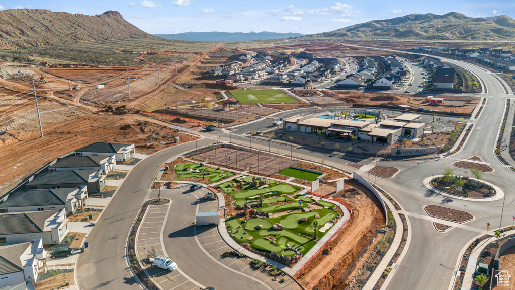 Aerial overview of property's location featuring mountains and nearby suburban area