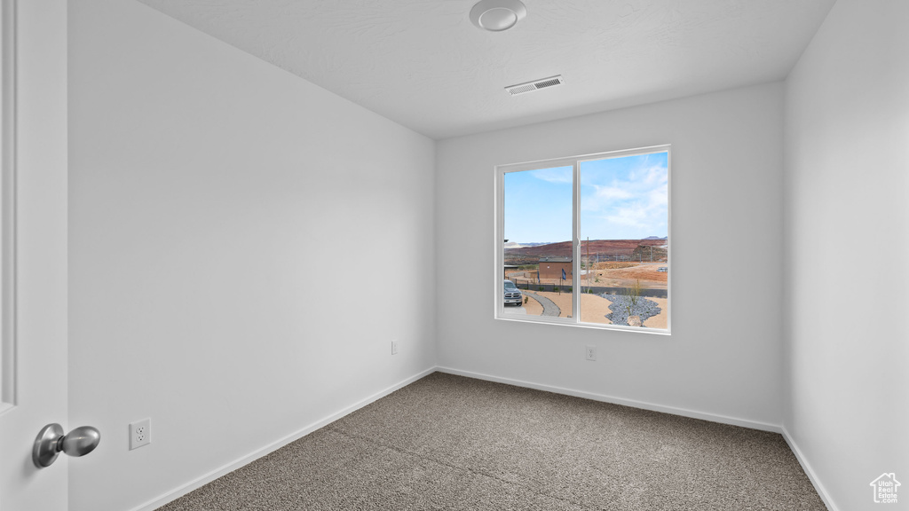 Spare room with carpet floors and baseboards
