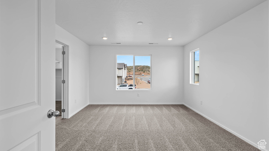 Empty room with carpet floors, baseboards, and recessed lighting