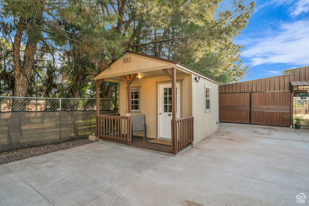 View of outdoor structure with fence and an outdoor structure