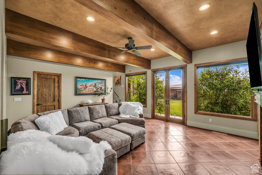 Living room with recessed lighting, tile patterned floors, baseboards, ceiling fan, and beam ceiling