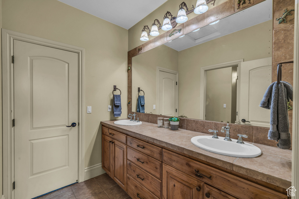 Bathroom featuring tile patterned flooring and double vanity