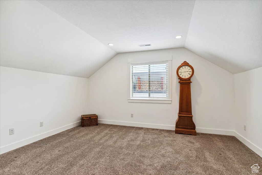 Additional living space featuring lofted ceiling, carpet flooring, baseboards, and recessed lighting
