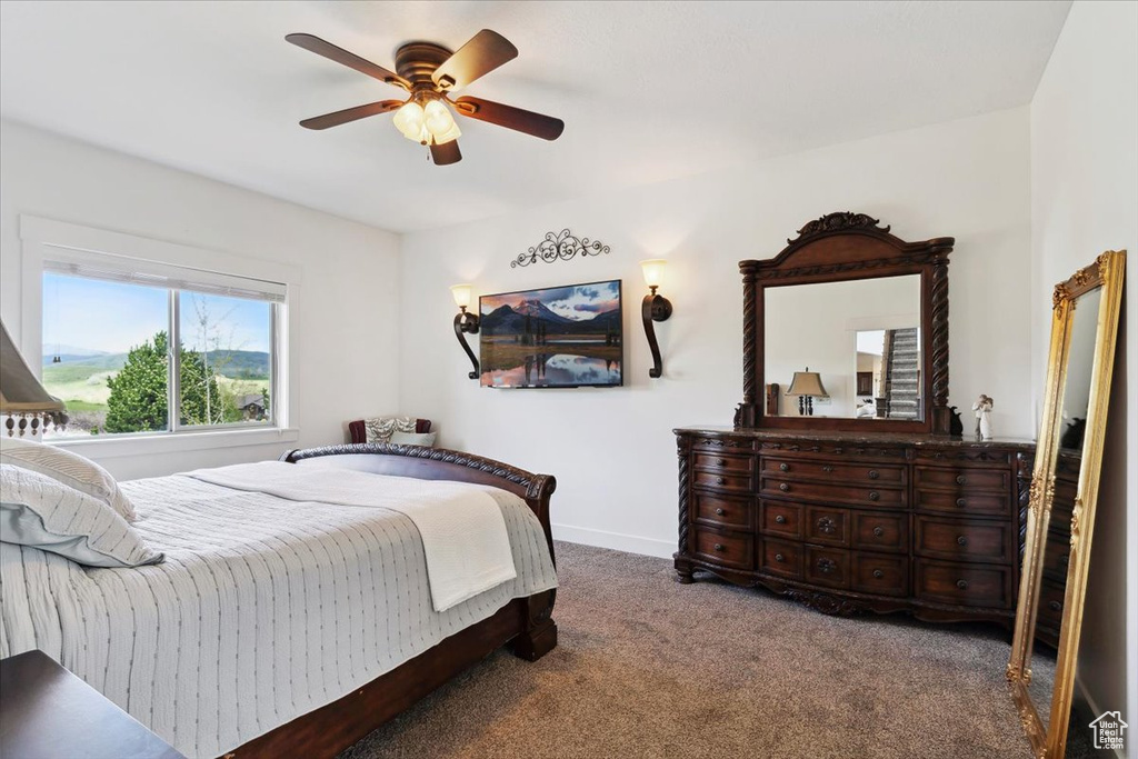 Bedroom with carpet floors, a ceiling fan, and baseboards