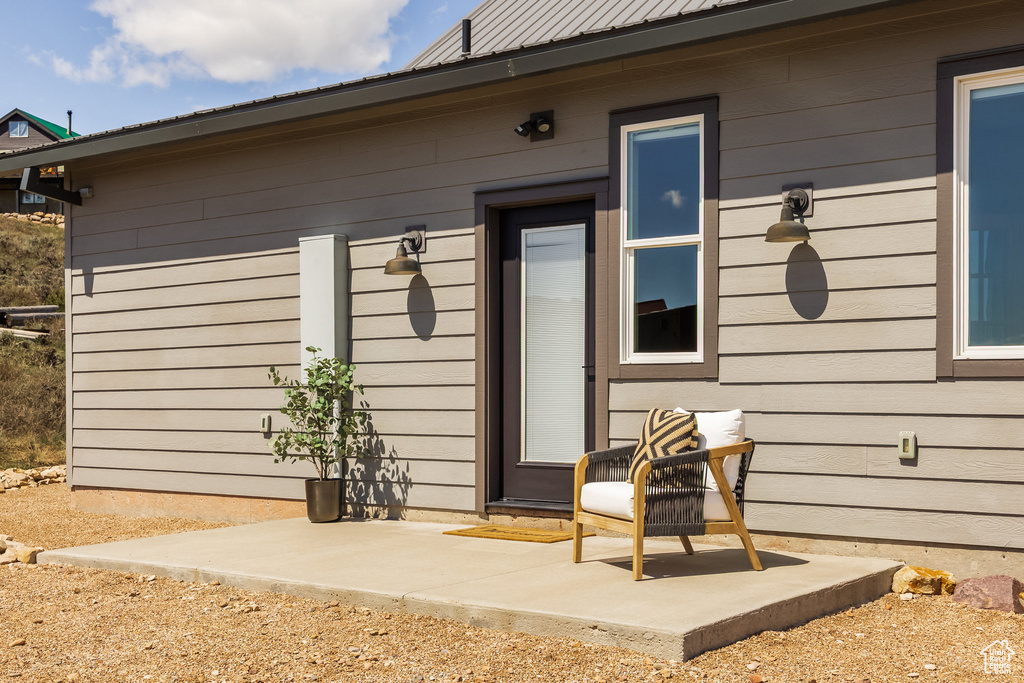 Doorway to property featuring metal roof